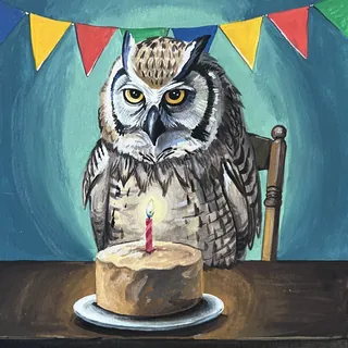 Owl sitting at table with birthday cake and lit candle