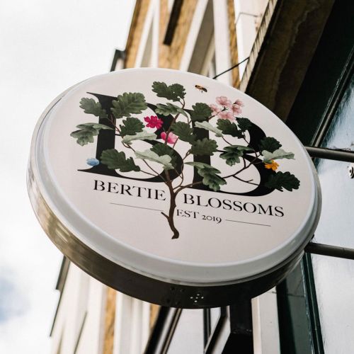 Round flower shop sign with botanical design by Kate Snell