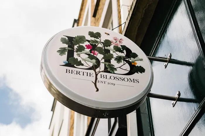 Round flower shop sign with botanical design by Kate Snell