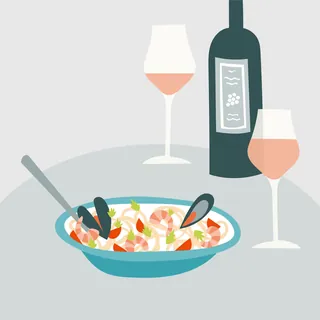 Seafood bowl, wine bottle, and two glasses on a table by Kate Snell