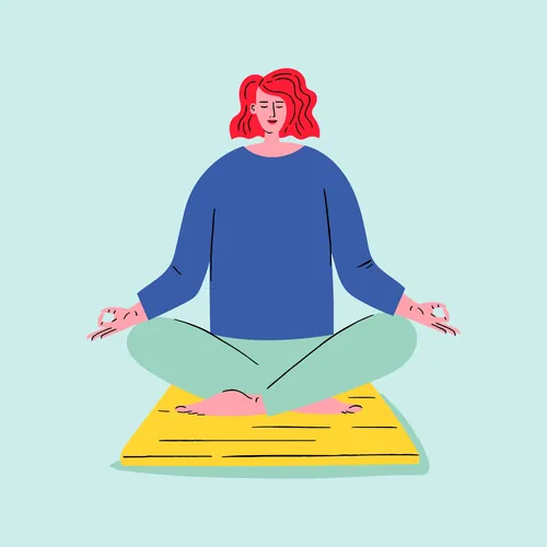 Person with red hair meditating cross-legged on yellow mat