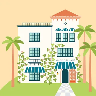 White Mediterranean building with blue windows, greenery, and surrounding palm trees