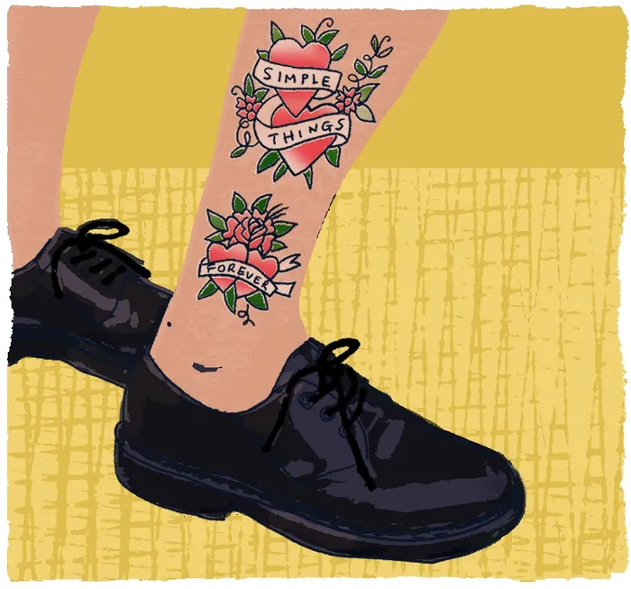 Leg with tattoos and black shoes by Kavel Rafferty