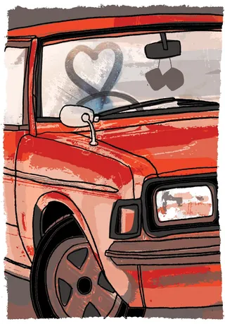 Red car with frosty windshield and heart drawn on glass