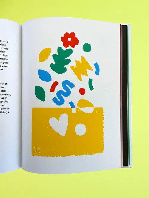 Colorful abstract shapes emerging from a yellow block on book page