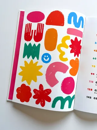 Colorful abstract shapes and symbols on an open book page