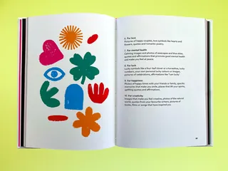 Open book showing colorful abstract shapes and text on yellow background
