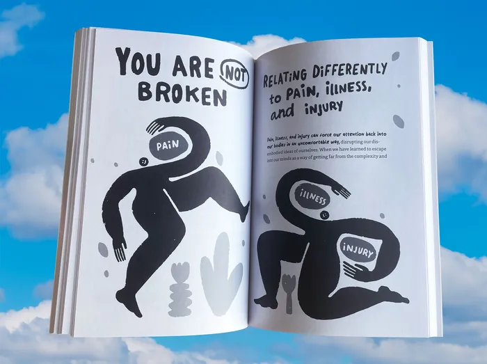 Open book with illustrations about pain, illness, and injury with motivational text