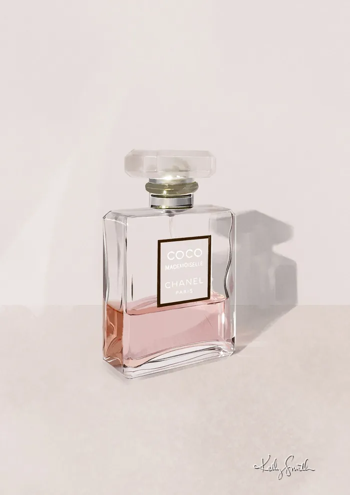 Coco Mademoiselle perfume bottle with pink liquid on light surface
