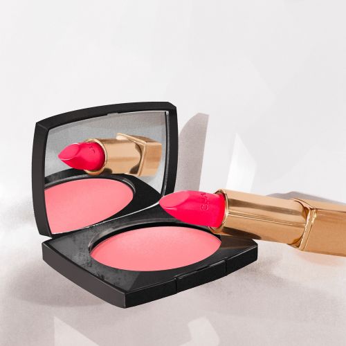 Chanel compact powder and red lipstick with reflection in mirror