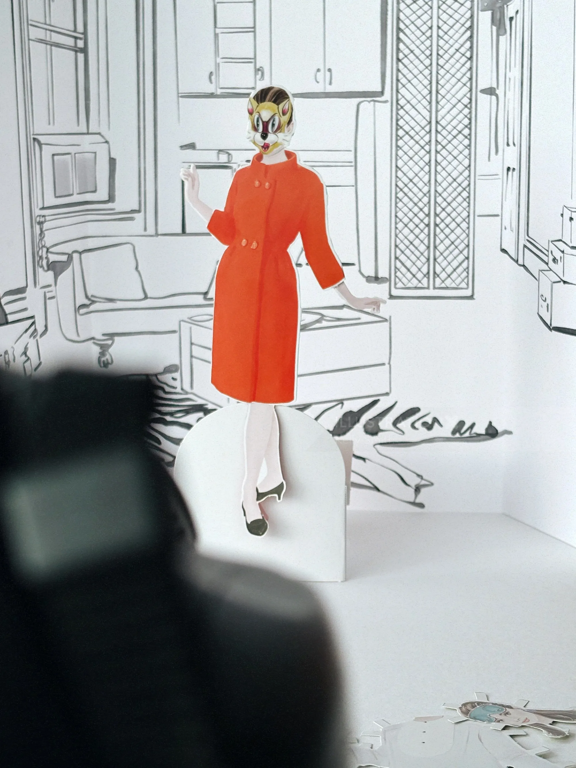 Paper doll of Audrey Hepburn wearing a red dress in a black and white room by Kelly Smith