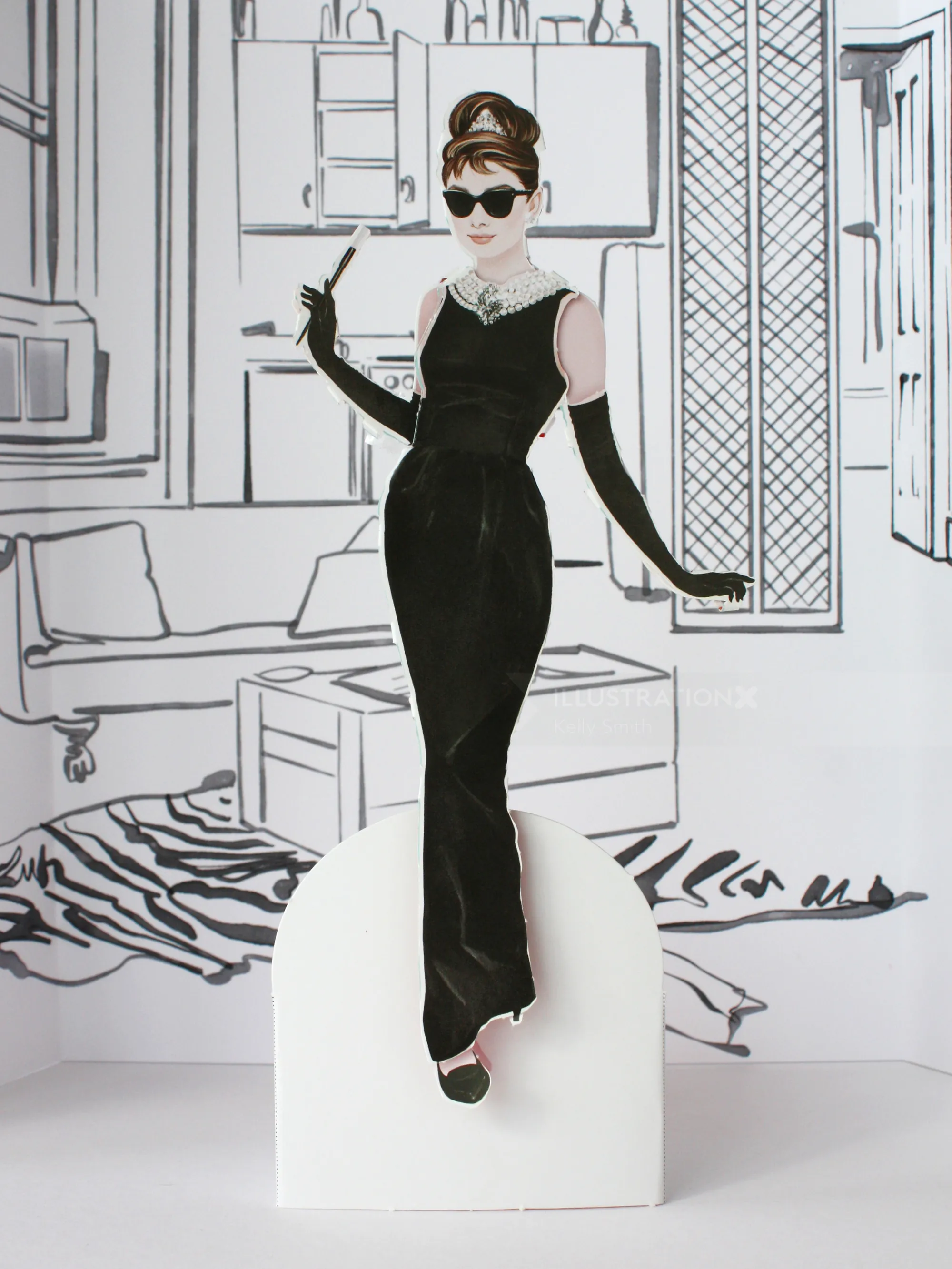 Illustration of Audrey Hepburn paper doll in black dress by Kelly Smith