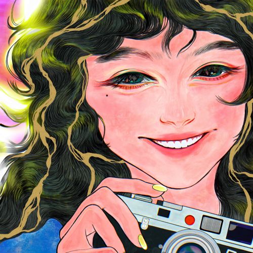 Smiling woman holding a camera with curly hair