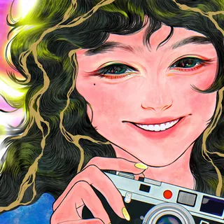 Smiling woman holding a camera with curly hair