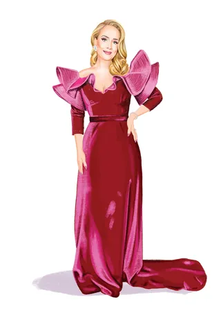 Blonde woman wearing a long red gown with large shoulder details