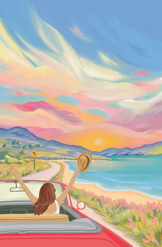 Woman in car raising hat while driving along a colorful coastal sunset