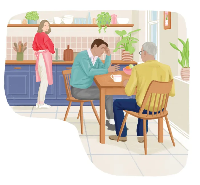 Young man looking stressed at a table with older man and woman in kitchen