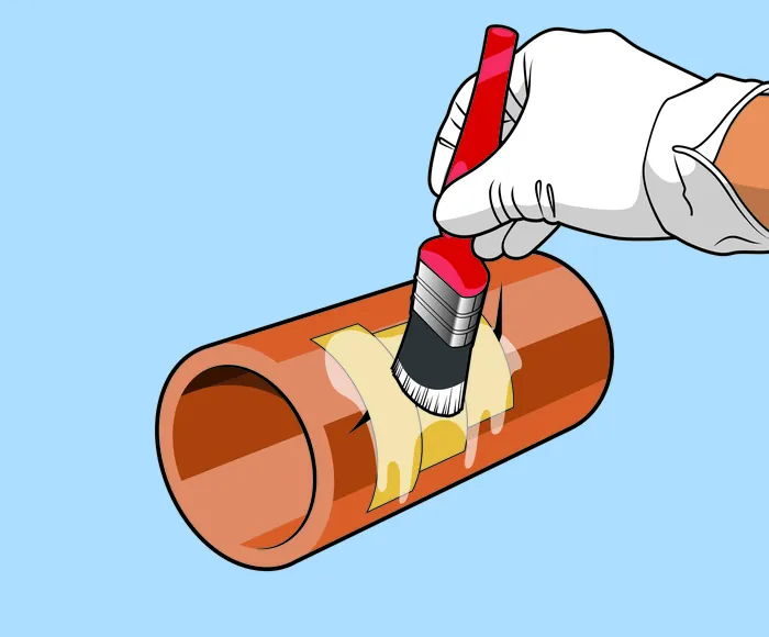 Gloved hand painting brown pipe section with red brush by Lee Montgomery