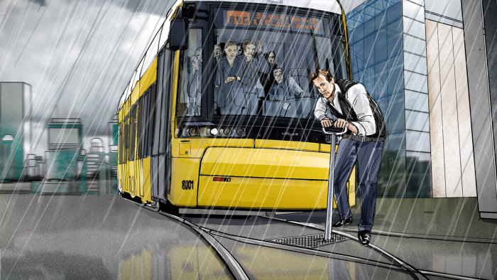 Homme fixant la ligne de tram par temps pluvieux