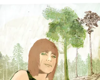 Woman with short hair standing in front of tall green trees