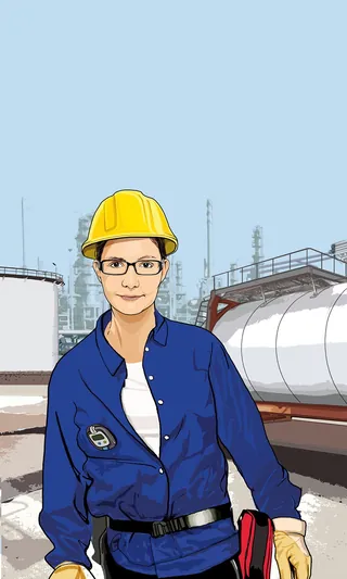 Woman engineer wearing hard hat and safety glasses at fuel tanks