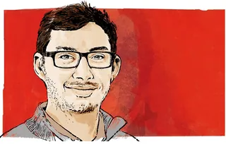 Smiling man wearing glasses with short hair on red background