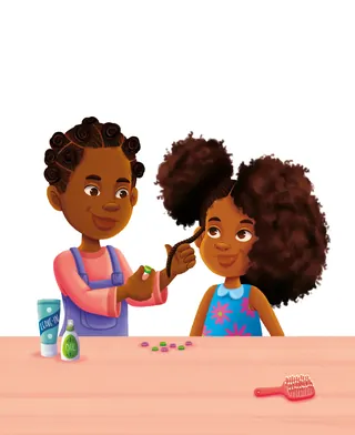 Girl styling another girl’s hair with hair accessories