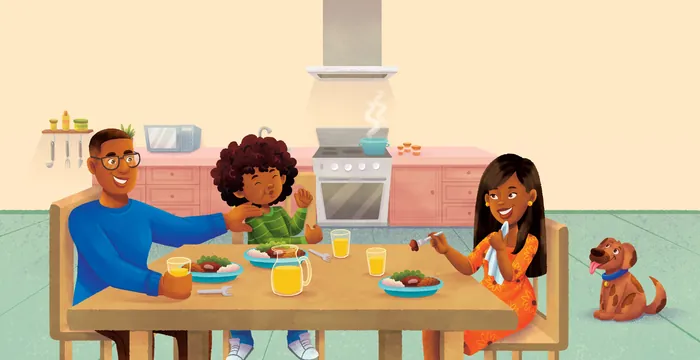 Family having breakfast at kitchen table with pet dog nearby