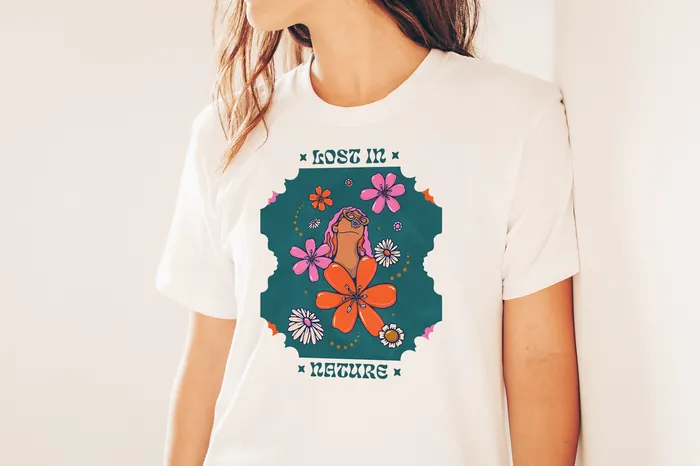 Woman in white t-shirt with colorful floral design and 'Lost Leisure' text by Lively Scout