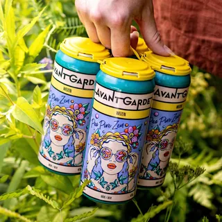 Hand holding six-pack of Avant Garde drinks with floral design cans