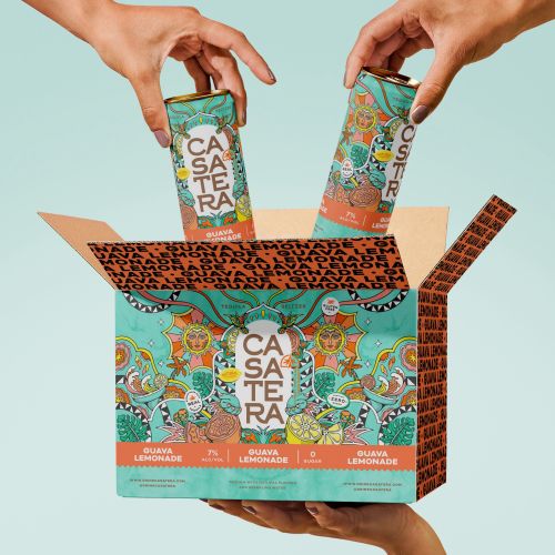 Hands placing Casa Tera guava lemonade cartons into box
