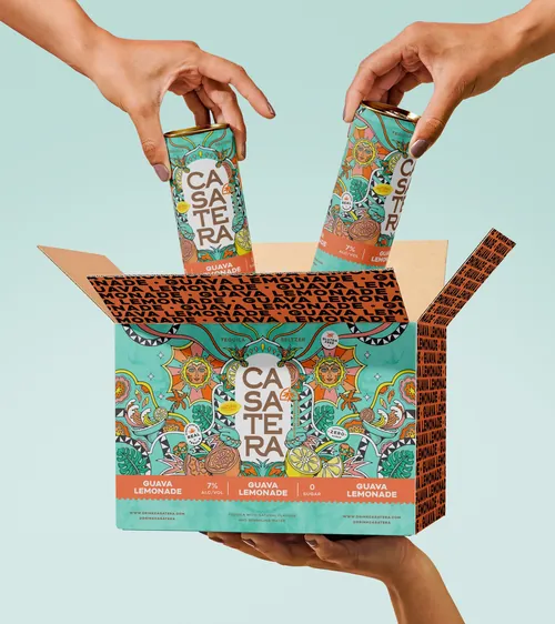 Hands placing Casa Tera guava lemonade cartons into box