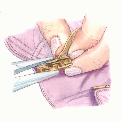 Garment-making hands attaching a zipper
