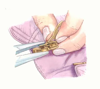 Garment-making hands attaching a zipper
