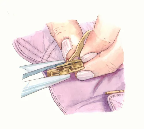 Garment-making hands attaching a zipper