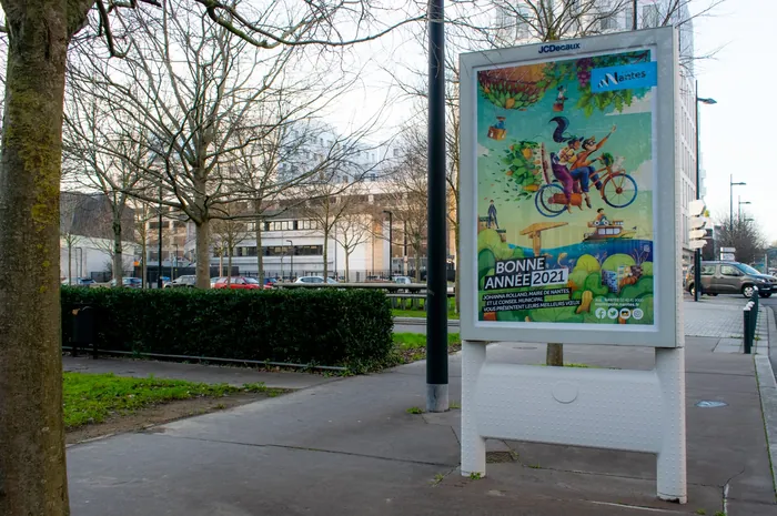 Street billboard showing colorful nature-themed ad with cyclist and animals by Luiza Laffitte