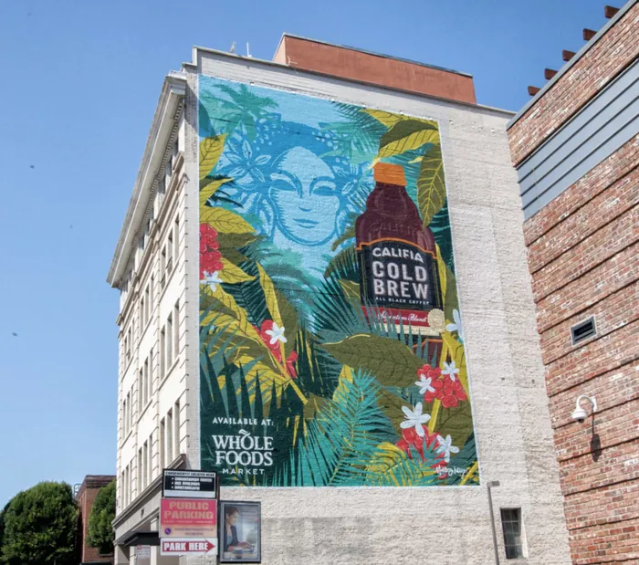 Mural of Califia Cold Brew bottle and tropical leaves on building exterior