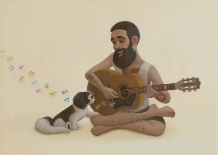 Man playing guitar with his dog listening nearby