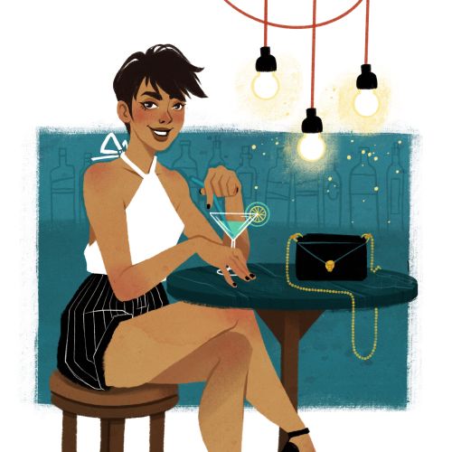 Woman in white top and striped skirt holding cocktail at bar.