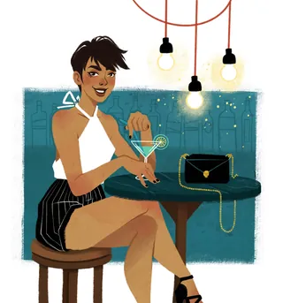 Woman in white top and striped skirt holding cocktail at bar.