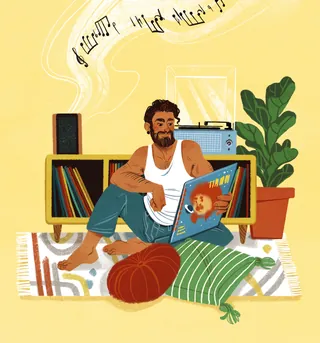 Man sitting on floor enjoying vinyl record near record player and plants