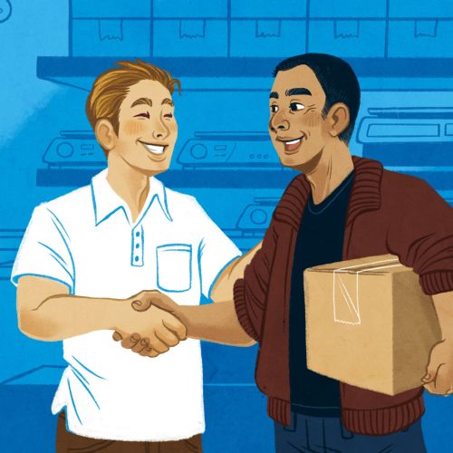 Two men shaking hands, one carrying a cardboard box in warehouse.