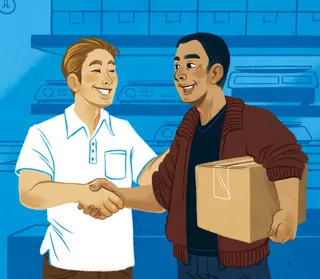 Two men shaking hands, one carrying a cardboard box in warehouse.
