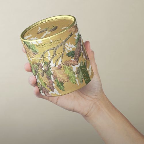 Hand holding scented candle with botanical illustration by Marieke Nelissen