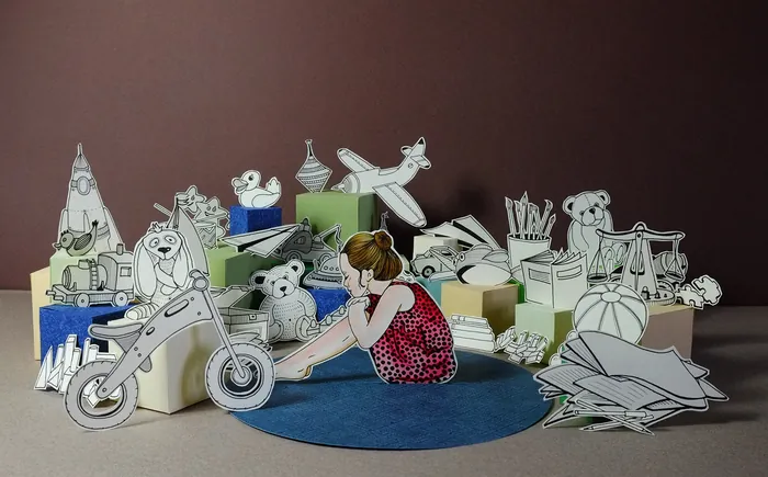 Girl sitting among black-and-white paper animal cutouts by Martha von Maydell