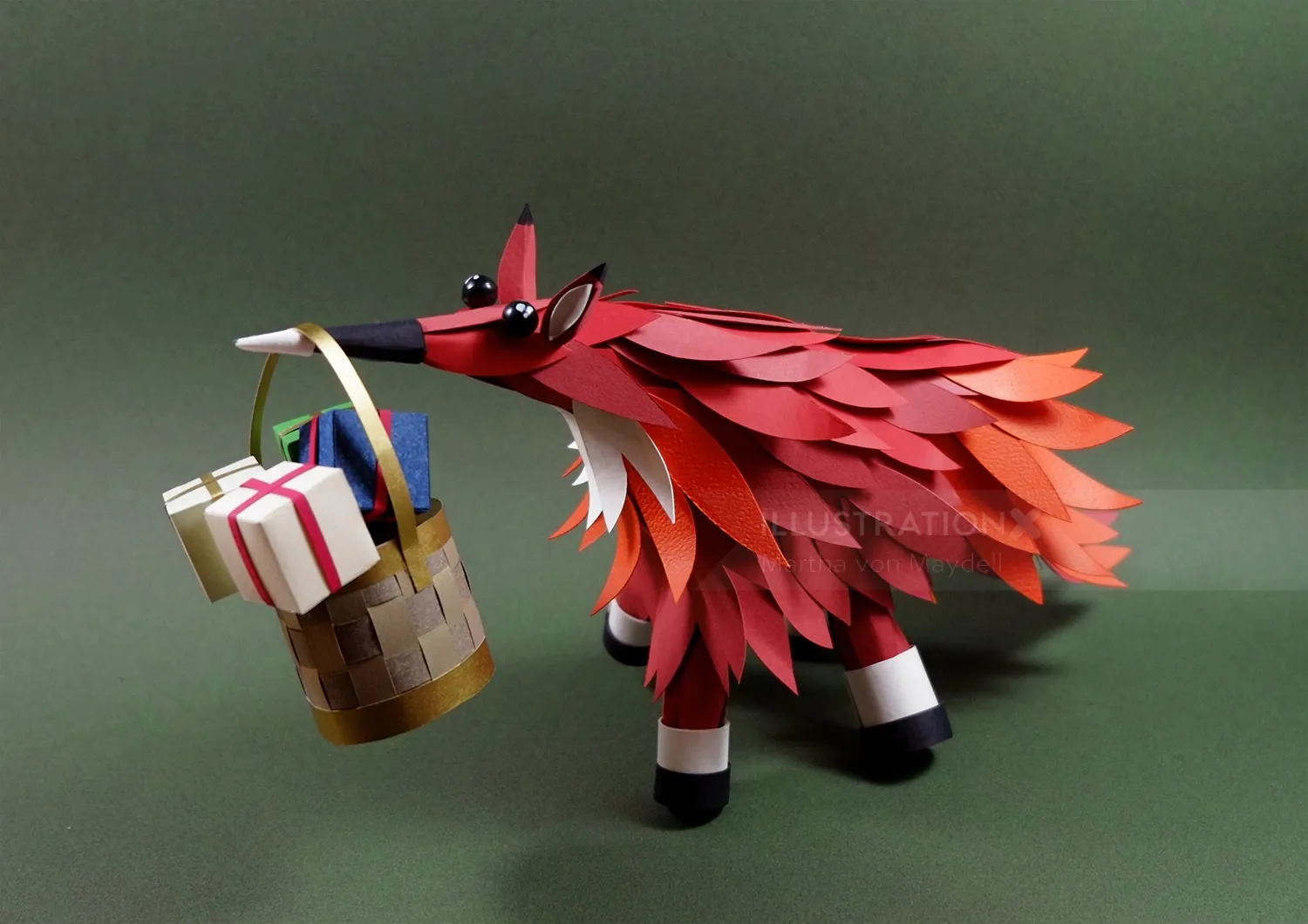 Paper fox sculpture holding a gift basket by Martha von Maydell