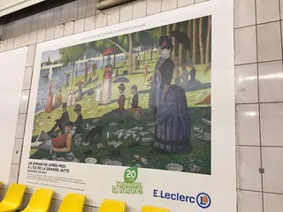 Georges Seurat painting showing people relaxing in a park by the water