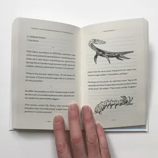 Open book showing text and illustrations of prehistoric reptiles