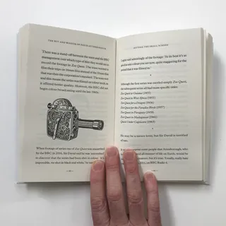 Open book with text and a detailed drawing of an antique device.