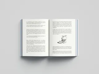 Open book showing text and a sketch of stacked teacups